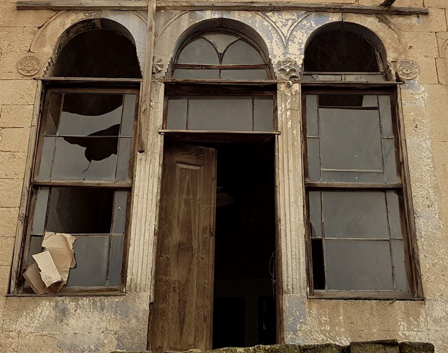 The main facade windows and door before restoration